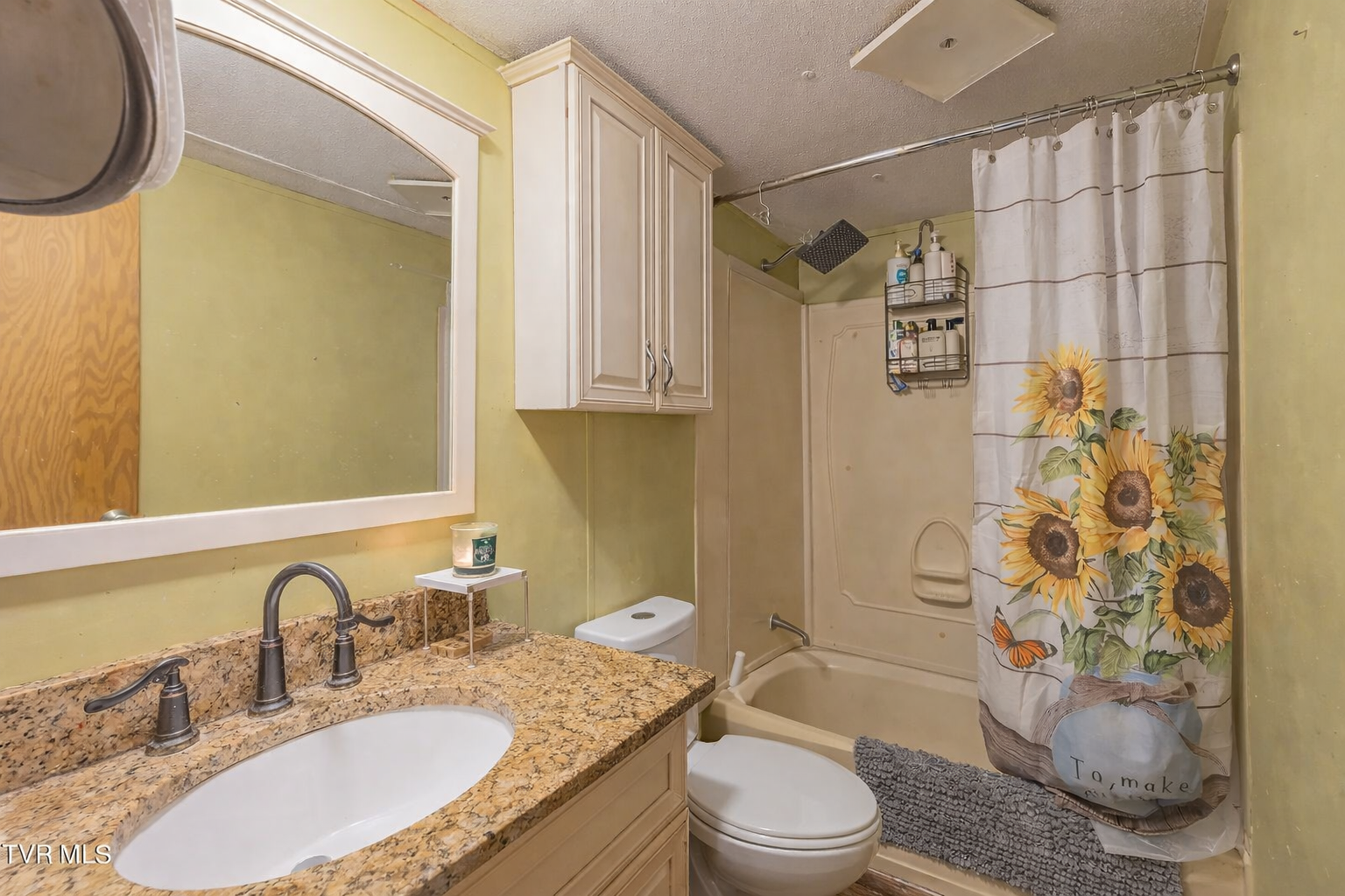 Bathroom with granite vanity and tub shower combo