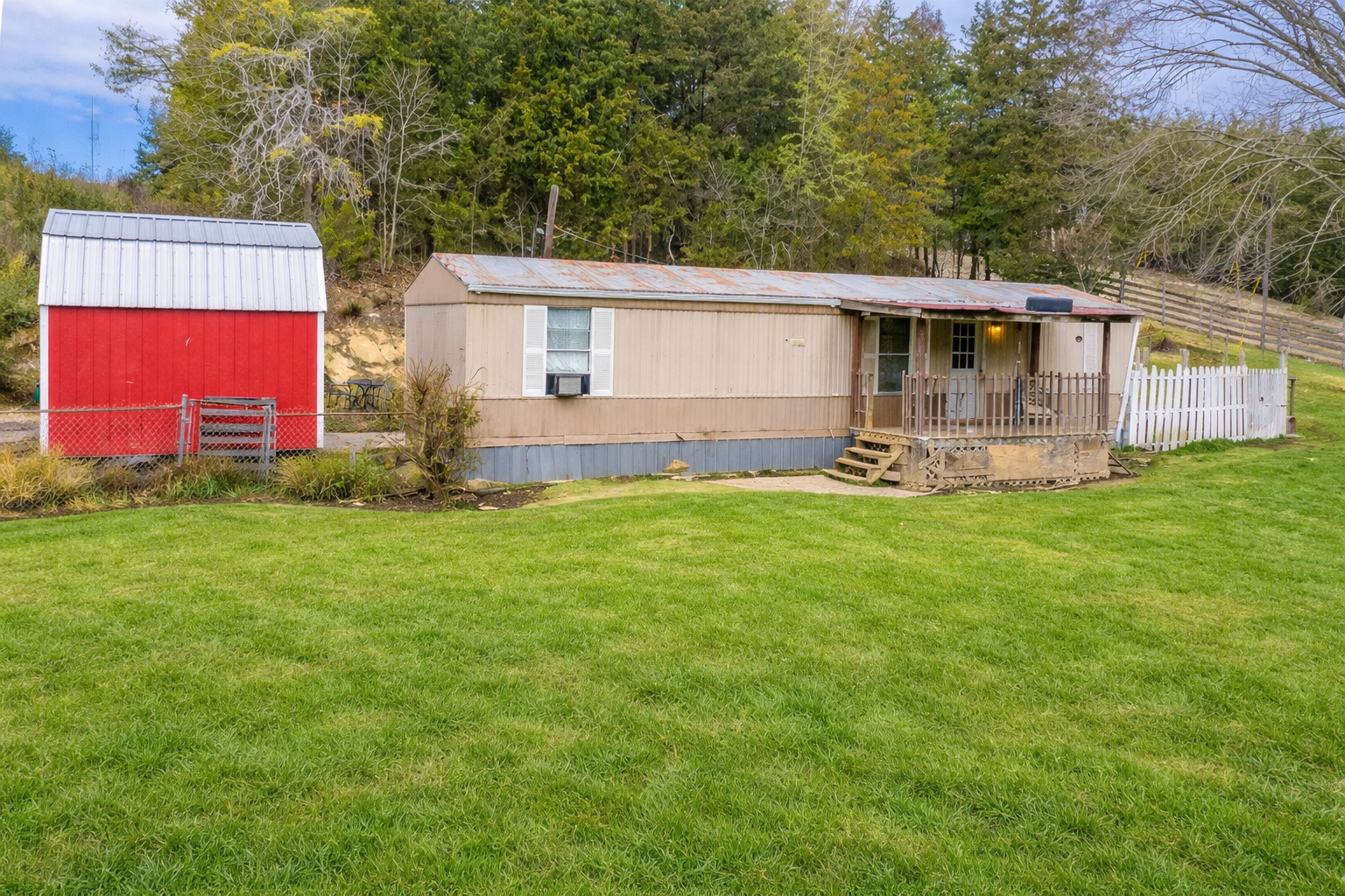 Exterior of the home with the red barn beside it